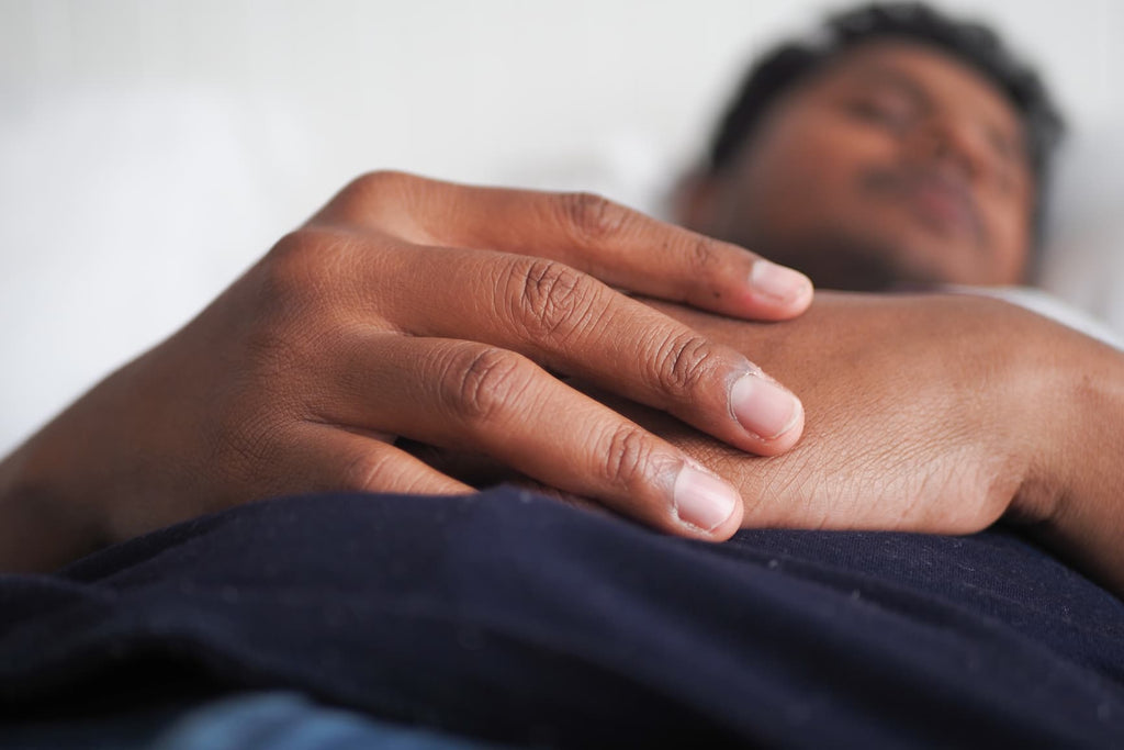 Close view of a man's hand resting while he sleeps, useful for estimating ring size secretly