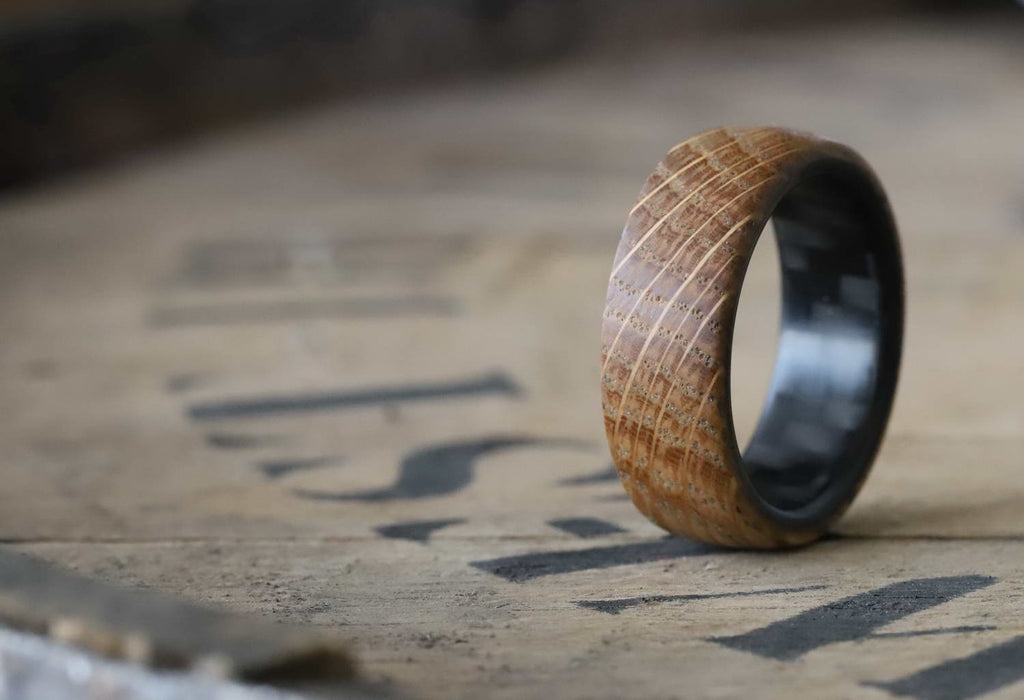 whiskey barrel ring with carbon fiber sleeve on a whiskey barrel lid